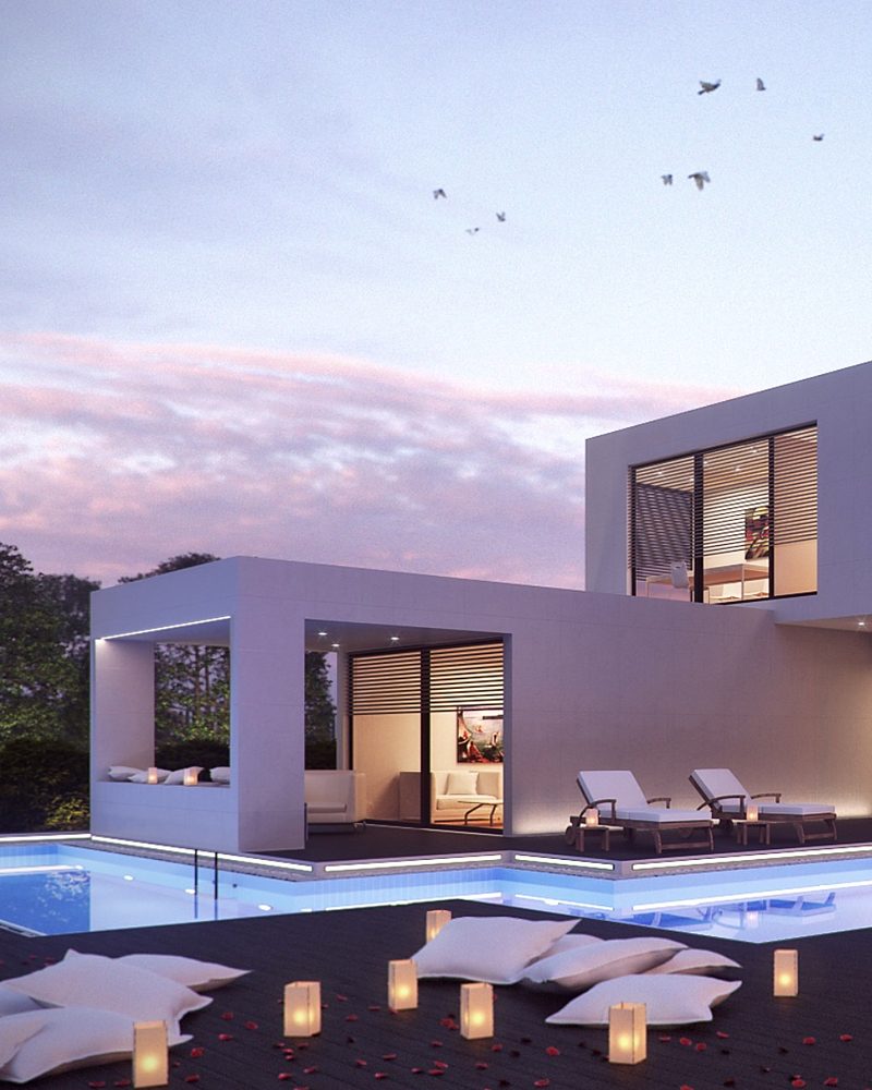 Modern home with a pool at dusk